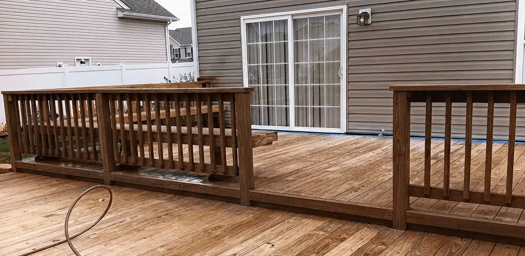 Deck sealing service protecting a backyard wood deck and railings in Arlington, TX