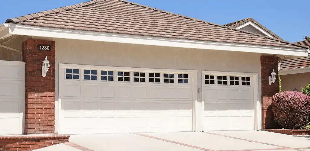 Residential garage door repair service for a double garage door in Arlington, TX