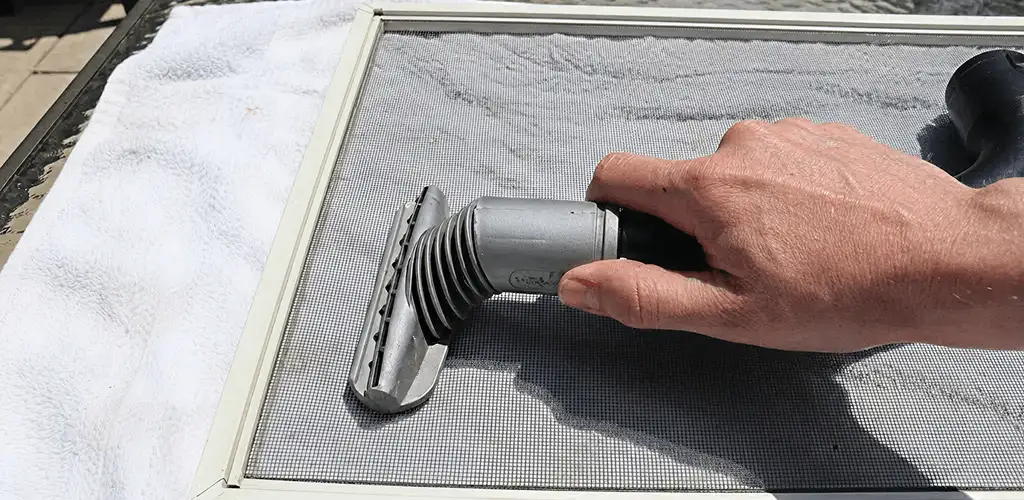 Window screen repair cleaning and fixing a damaged screen mesh in Arlington, TX